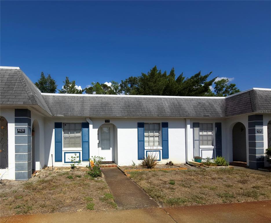 Undisclosed Address New Port Richey, FL 34652 - Photo 4 of 25 a front view of a house with a yard