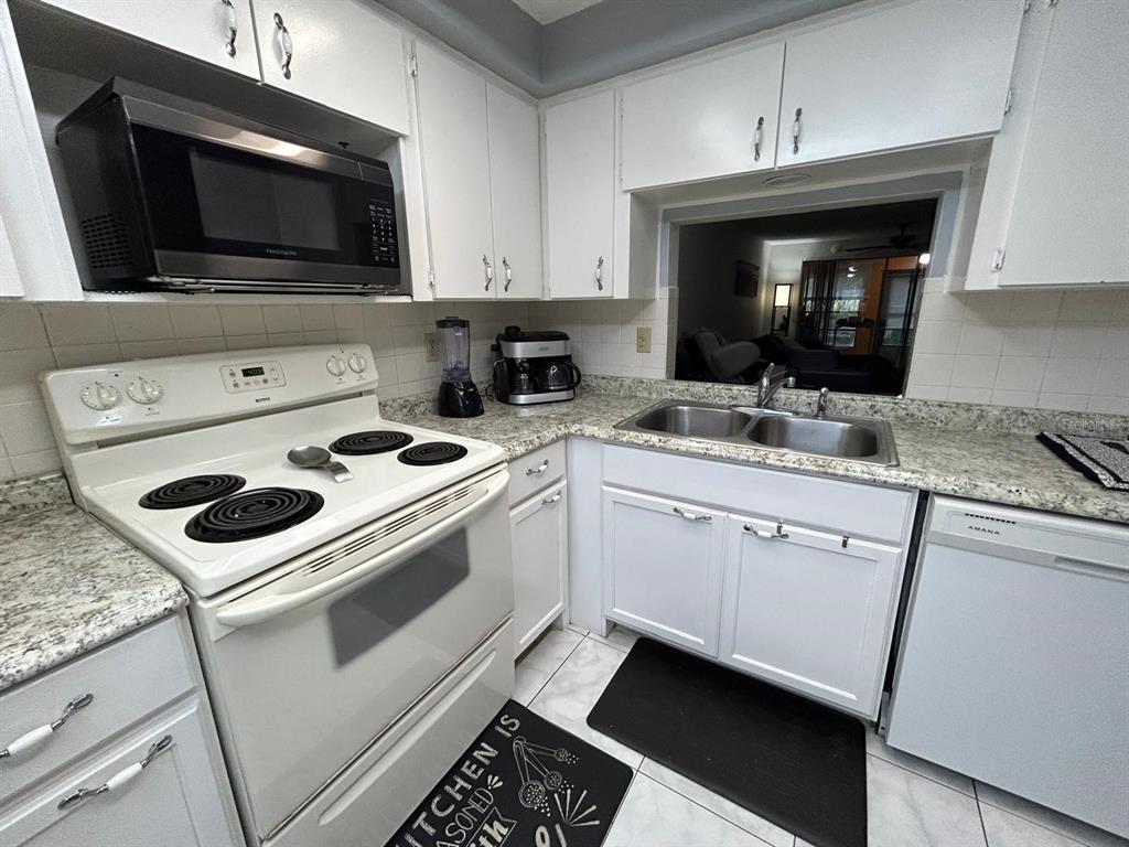 Undisclosed Address New Port Richey, FL 34652 - Photo 8 of 25 a kitchen with a stove and a microwave