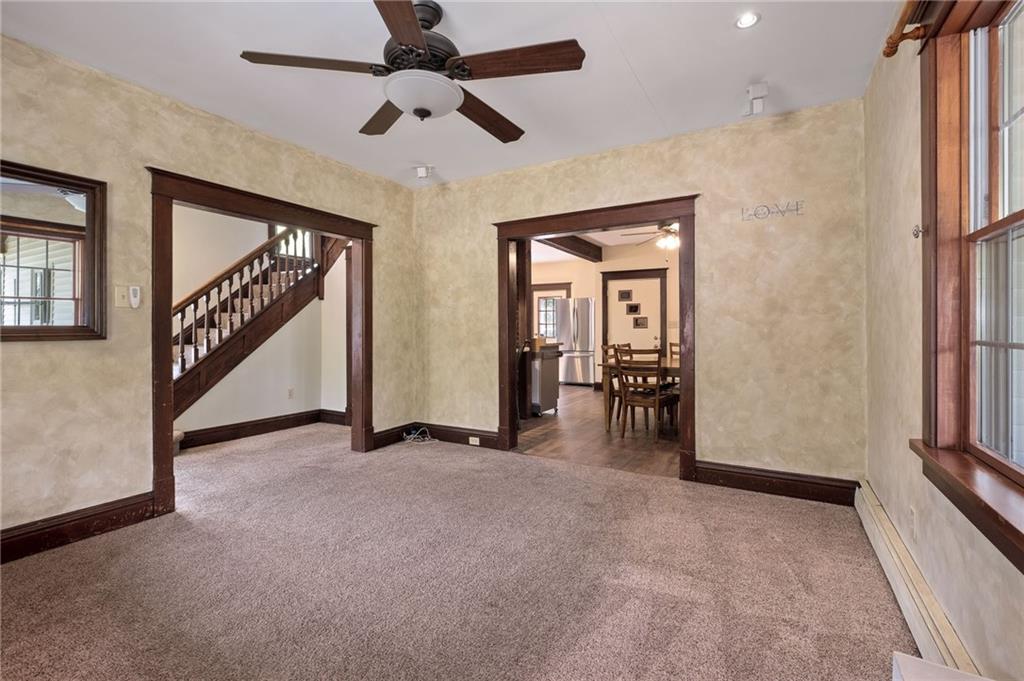 212 Highway 68 Rochester, PA 15074 - Photo 8 of 50 en view interior of a house with wooden floor stairs and a chandelier fan