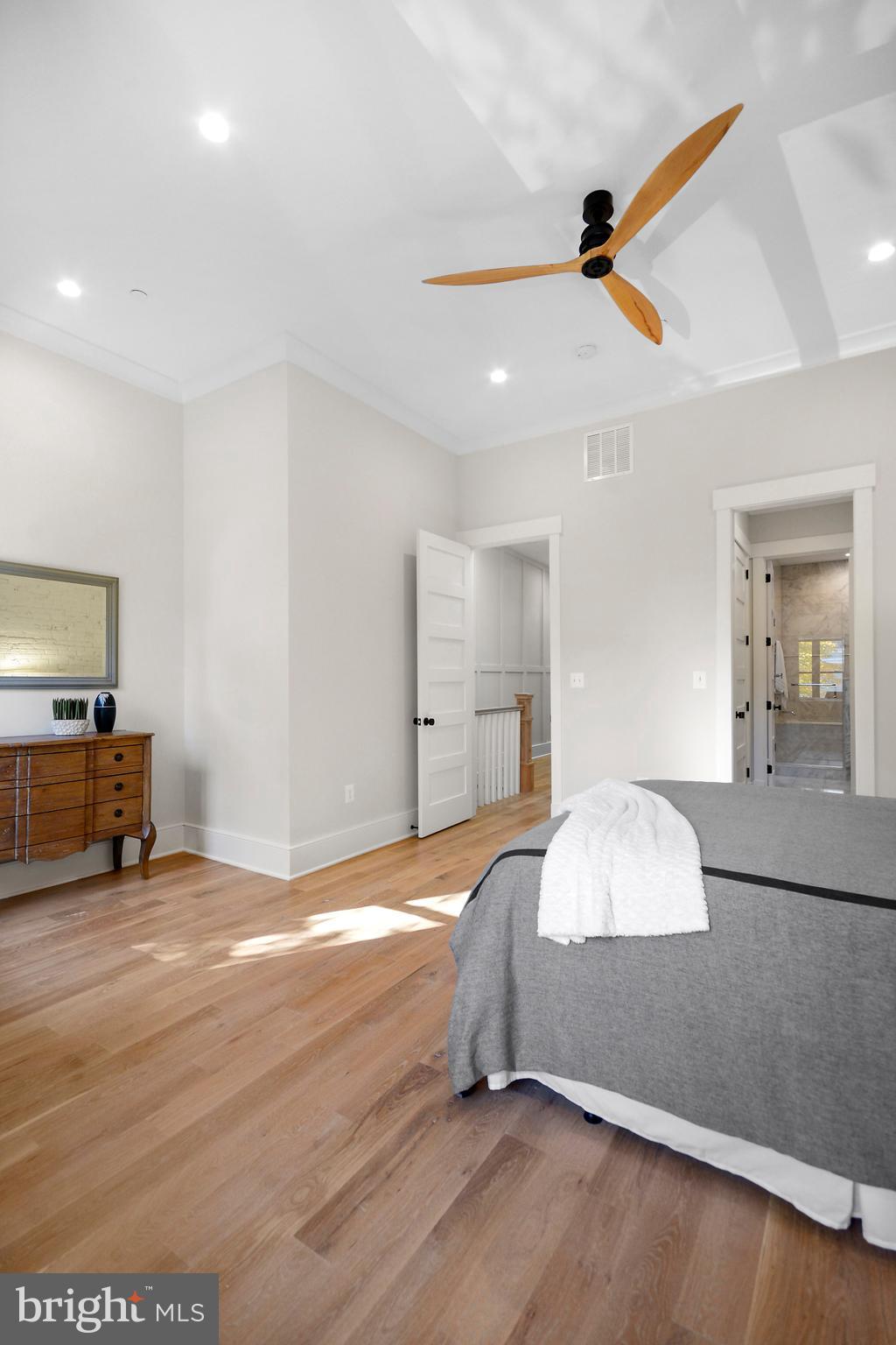 1432 G Street Southeast Washington, DC 20003 - Photo 15 of 35 a spacious bedroom with a bed and a flat screen tv