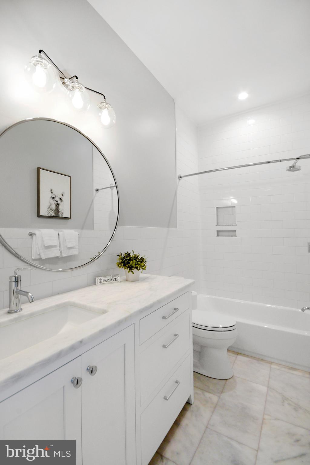 1432 G Street Southeast Washington, DC 20003 - Photo 19 of 35 a bathroom with a granite countertop toilet sink and mirror