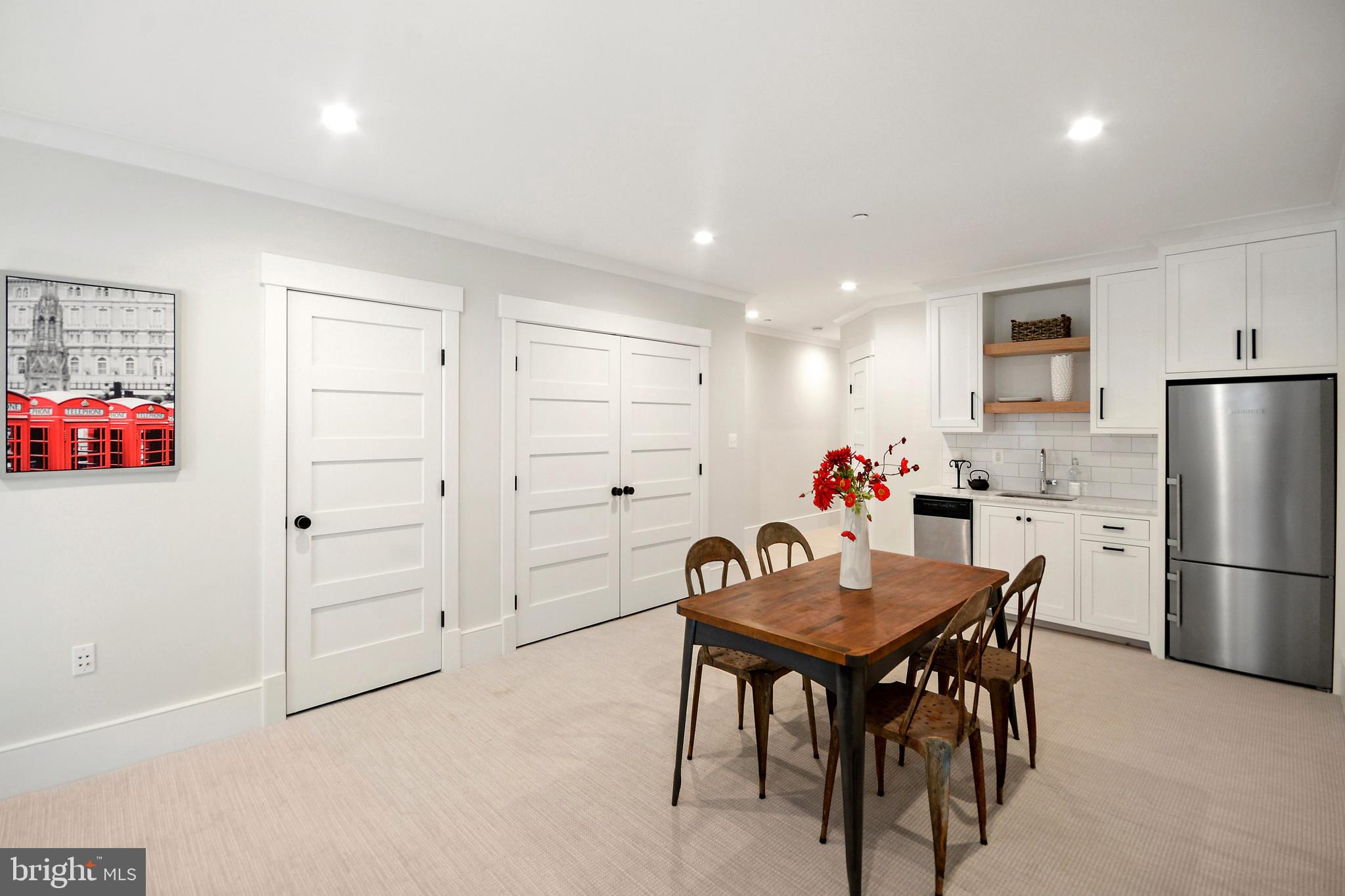 1432 G Street Southeast Washington, DC 20003 - Photo 24 of 35 a kitchen with white cabinets and refrigerator