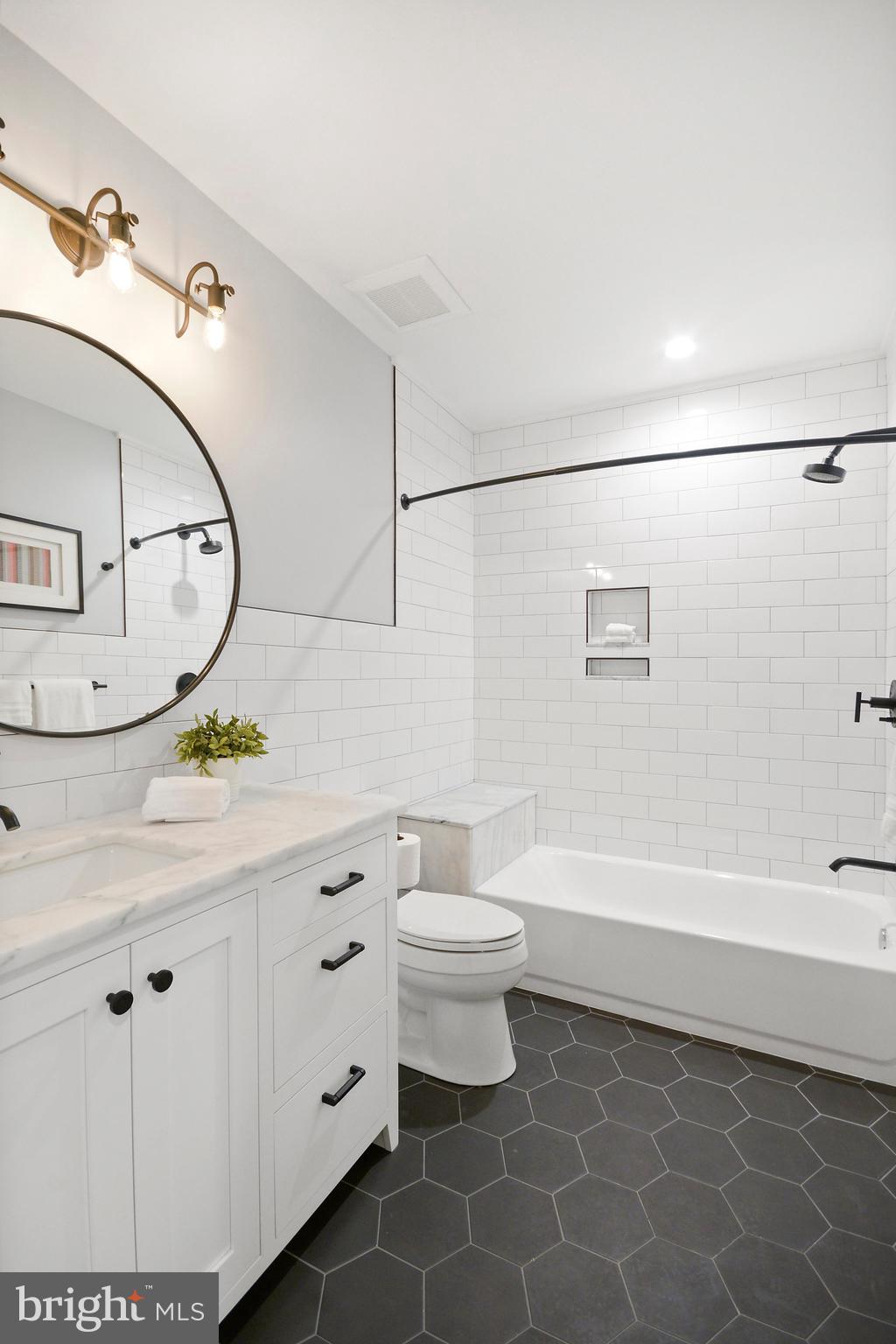 1432 G Street Southeast Washington, DC 20003 - Photo 26 of 35 a bathroom with a sink a toilet and bathtub