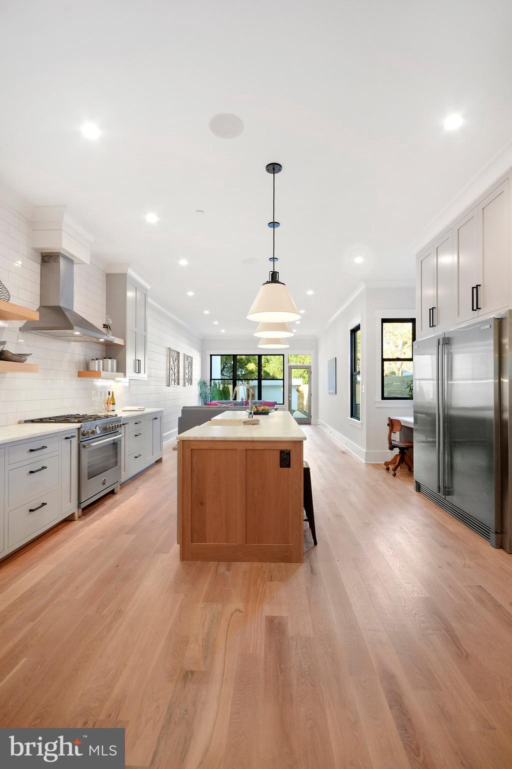 1432 G Street Southeast Washington, DC 20003 - Photo 7 of 35 a large kitchen with stainless steel appliances kitchen island a large counter top a sink a stove and a center island