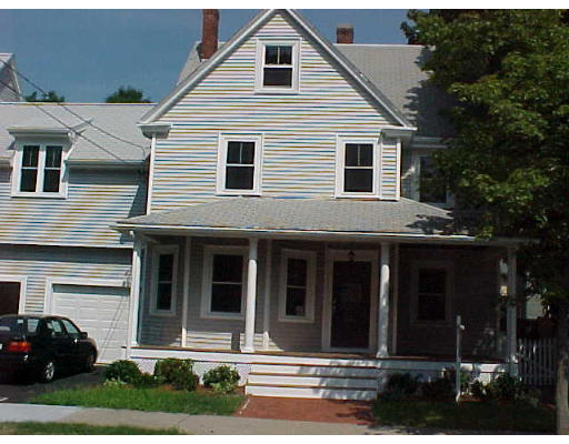 9 Delmore Road, Unit 1 9 Newton, MA 02461 - Photo 1 of 1 a view of a white house with large windows and a small yard