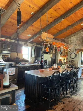 a kitchen with a sink dishwasher and a stove with wooden floor