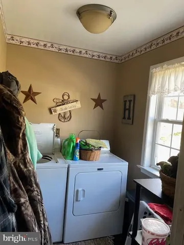 a kitchen with stainless steel appliances granite countertop a stove a sink and a dining table