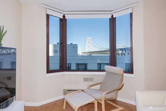 a view of a room that has a table and a chair in it