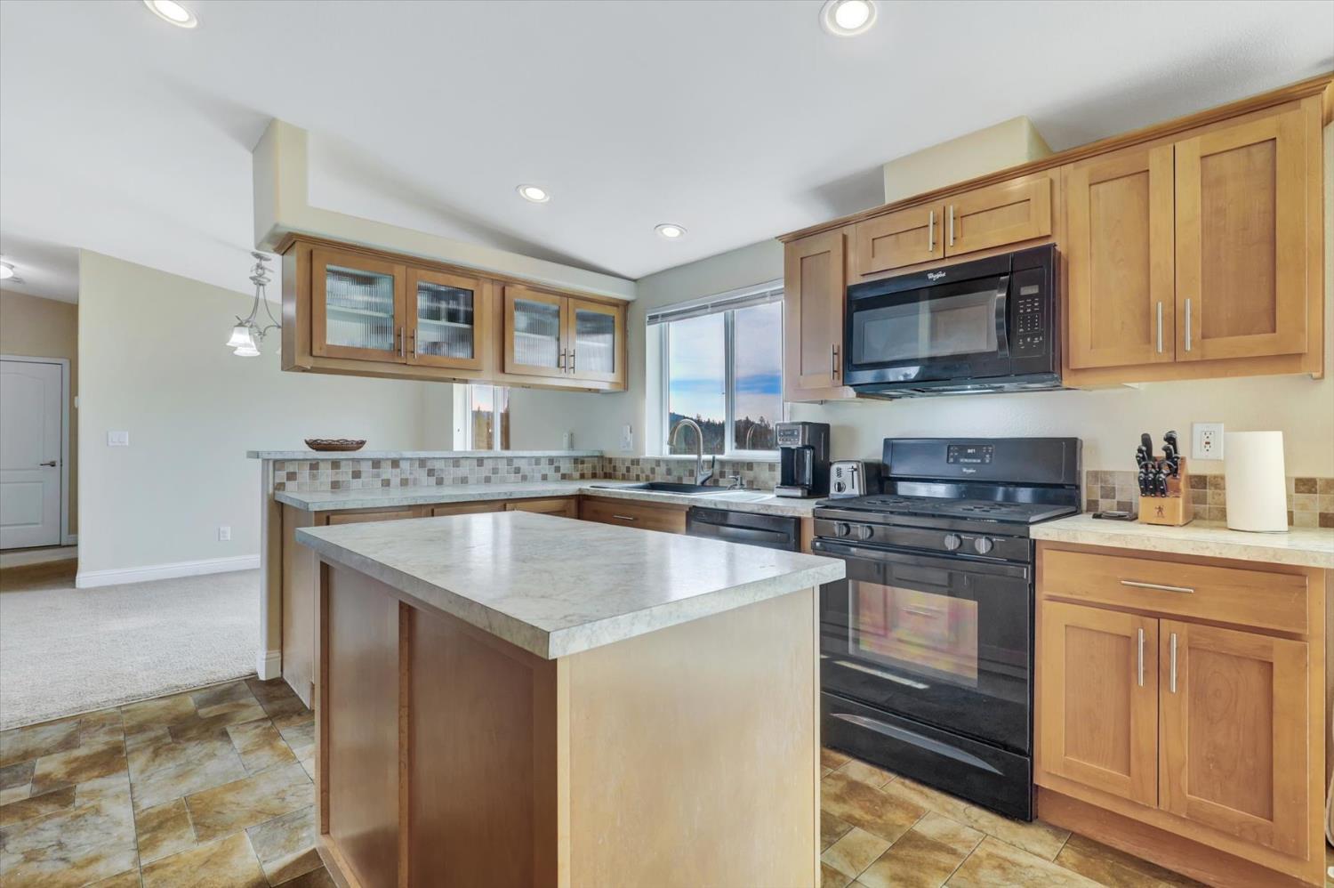 13886 Meadow Valley Road Dobbins, CA 95935 - Photo 14 of 99 a kitchen with stainless steel appliances granite countertop a sink stove and microwave