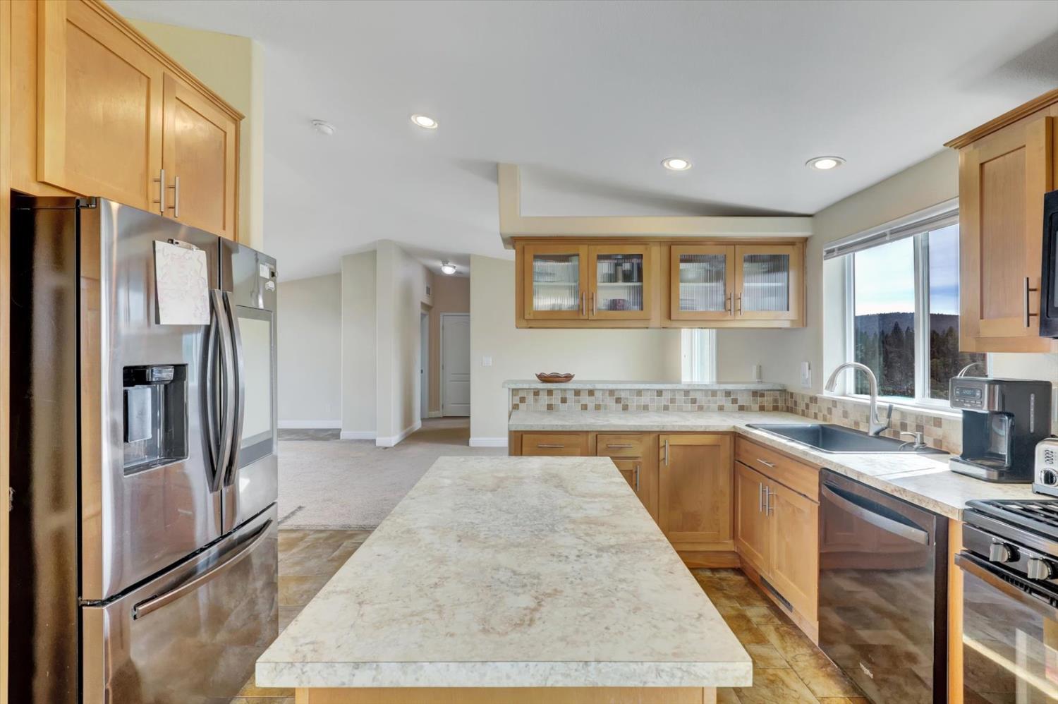 13886 Meadow Valley Road Dobbins, CA 95935 - Photo 15 of 99 a kitchen with stainless steel appliances granite countertop a refrigerator and a sink
