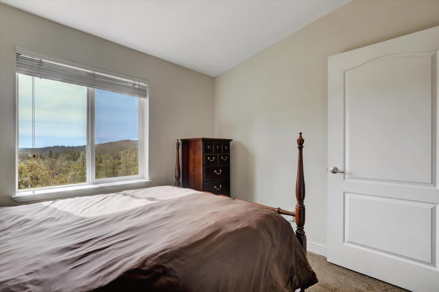 13886 Meadow Valley Road Dobbins, CA 95935 - Photo 32 of 99 a bedroom with a bed and a large window