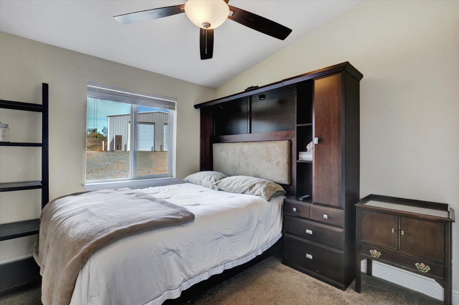 13886 Meadow Valley Road Dobbins, CA 95935 - Photo 41 of 99 a bedroom with a bed and a flat tv screen on a dresser