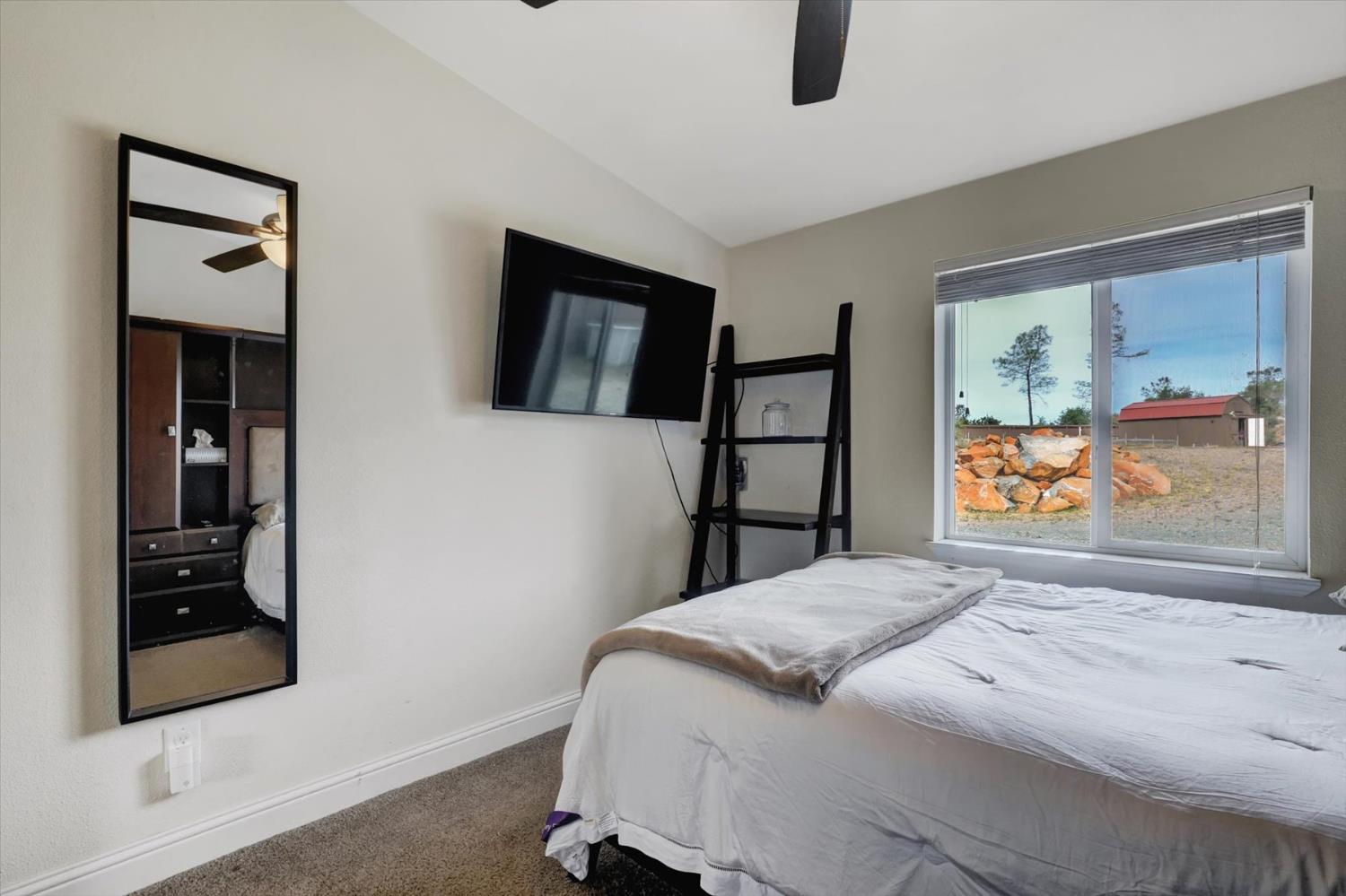 13886 Meadow Valley Road Dobbins, CA 95935 - Photo 42 of 99 a bedroom with a bed and a painting on the wall
