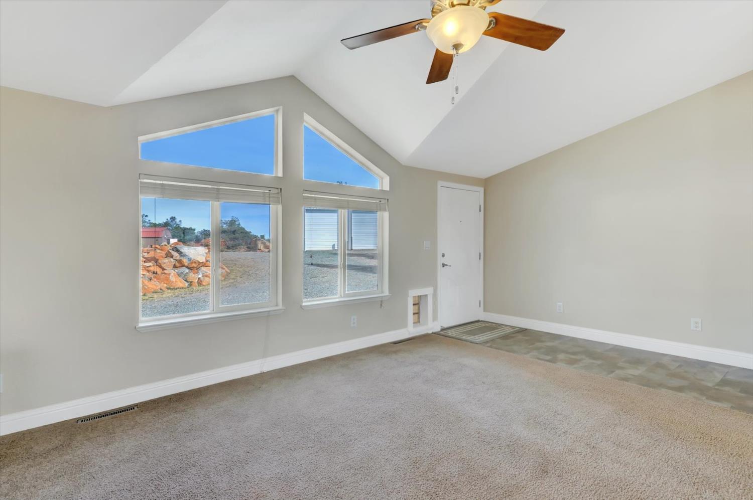 13886 Meadow Valley Road Dobbins, CA 95935 - Photo 6 of 99 an empty room with chandelier fan and windows