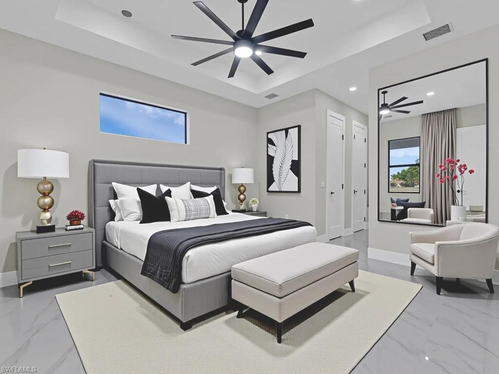 3300 3rd Street Southwest Lehigh Acres, FL 33976 - Photo 13 of 21 Bedroom featuring a tray ceiling, marble finish flooring, and recessed lighting