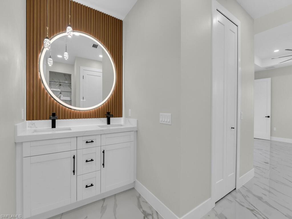 3300 3rd Street Southwest Lehigh Acres, FL 33976 - Photo 15 of 21 Bathroom featuring light marble finish floors, double vanity, and recessed lighting
