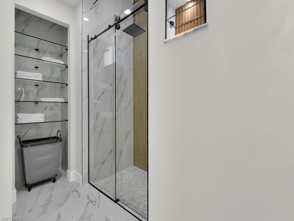 3300 3rd Street Southwest Lehigh Acres, FL 33976 - Photo 16 of 21 Full bathroom with a marble finish shower and marble look tiles