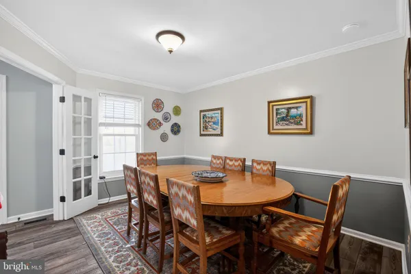 a view of a dining room with furniture and wooden floor