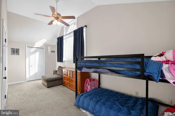 a living room with furniture and a ceiling fan
