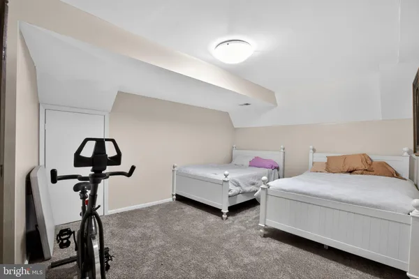 a bedroom with a bed and gym equipment