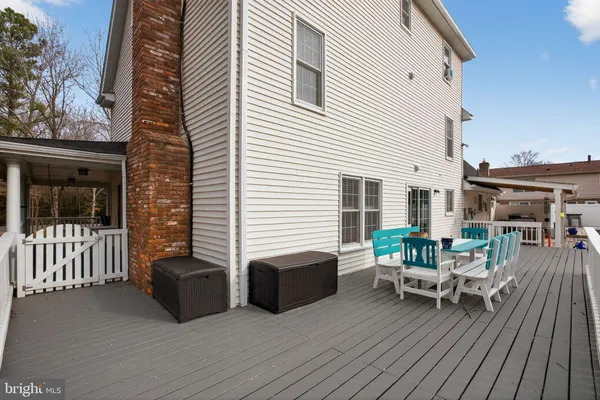 a view of a house with a patio and a yard