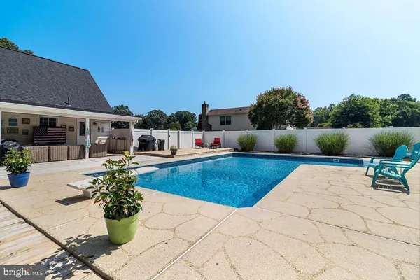 a view of a patio with swimming pool table and chairs