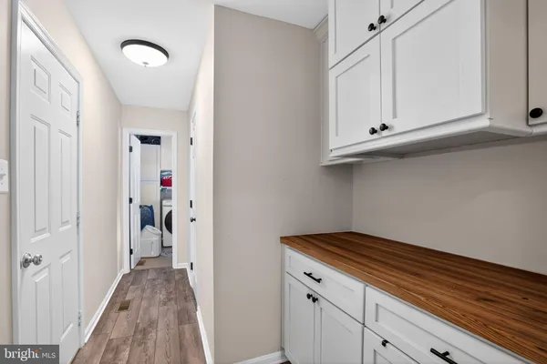 a view of hallway with closet and wooden floor