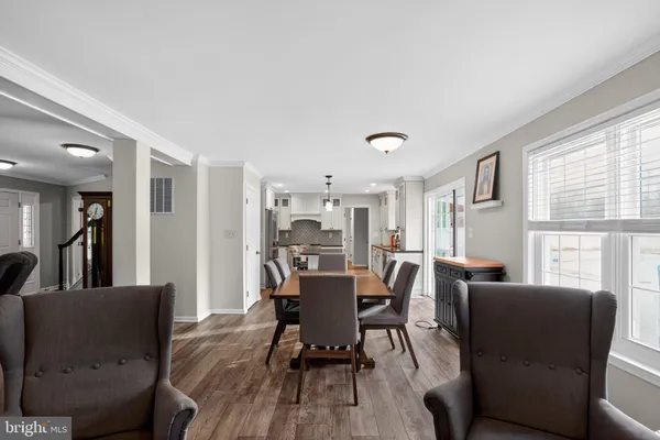 a view of a dining room with furniture window and wooden floor