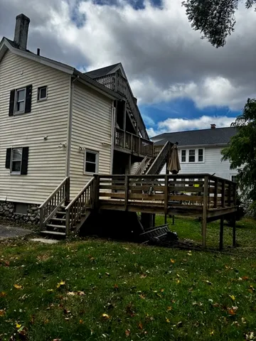 a view of a house with backyard and sitting area