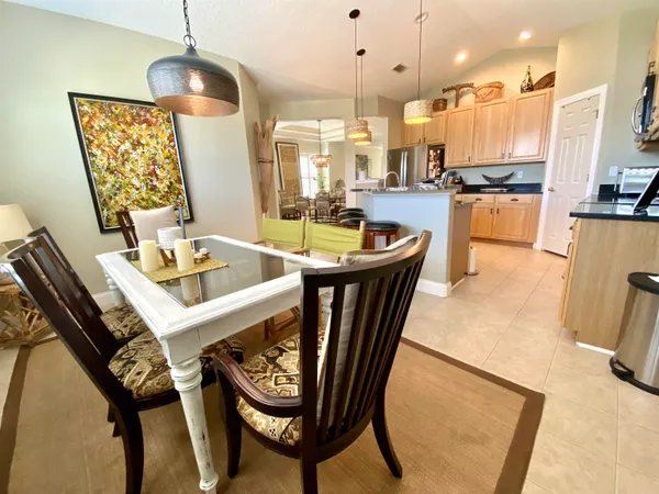 a dining room with furniture and wooden floor