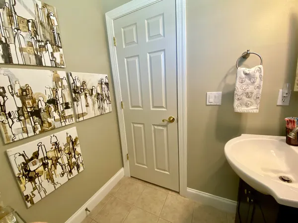 a bathroom with a sink and mirror with bathtub