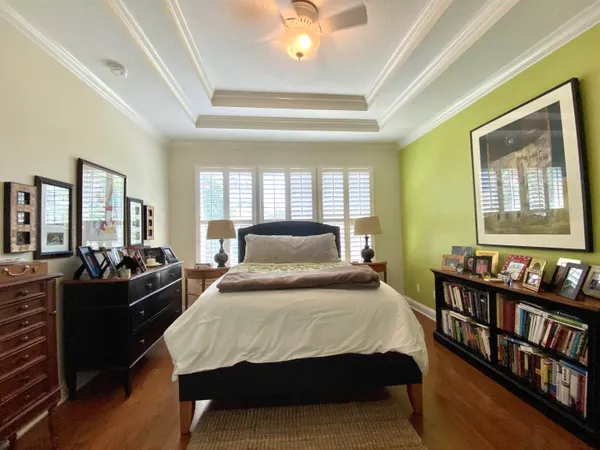 a bedroom with a bed a bookshelf and a book shelf