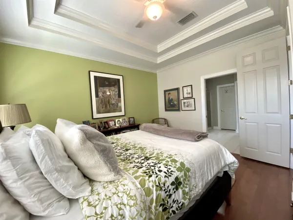 a bedroom with a bed and a chandelier