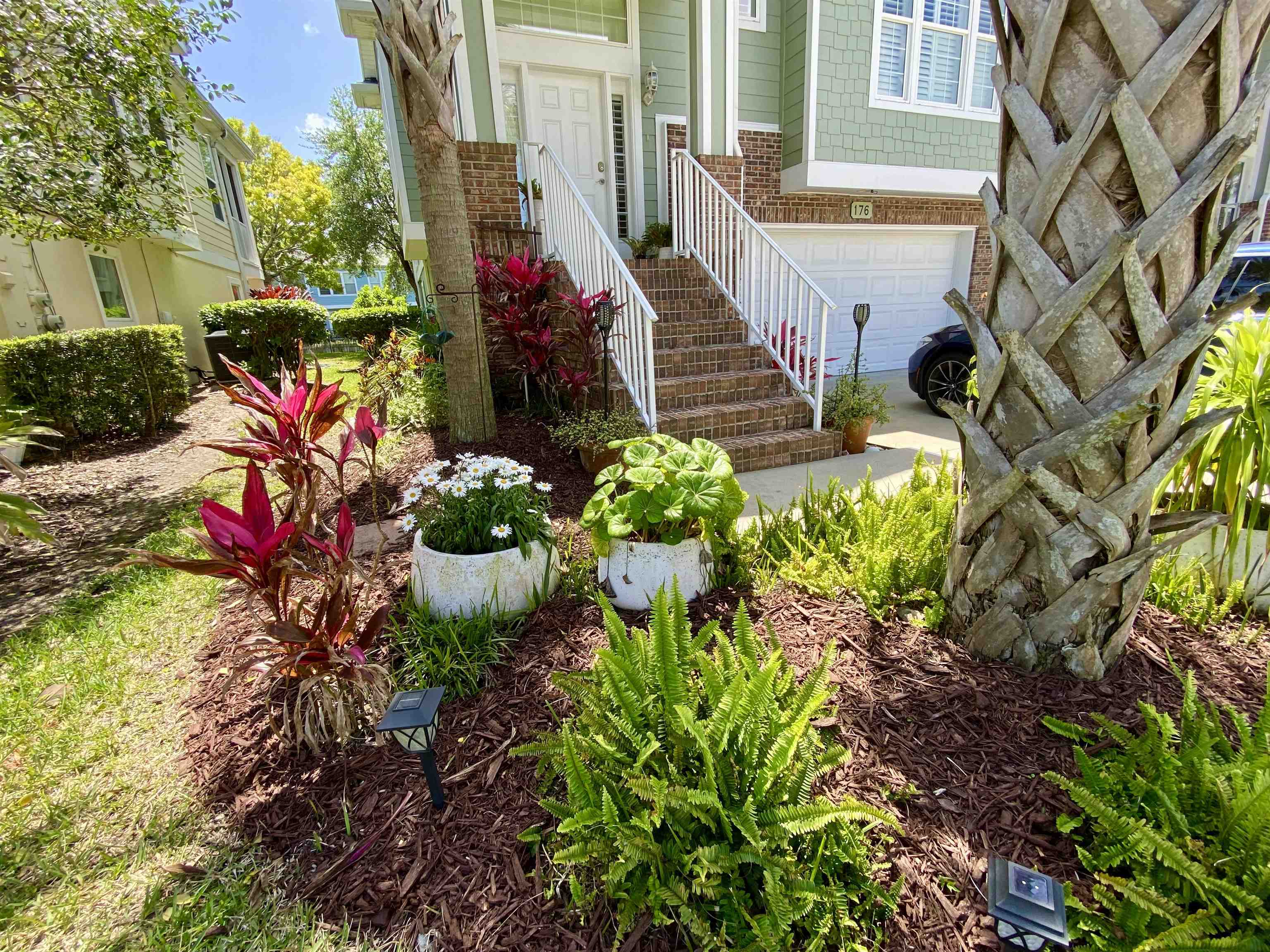 176 Sunset Circle North St. Augustine, FL 32080 - Photo 2 of 44 a front view of a house with a yard and fountain