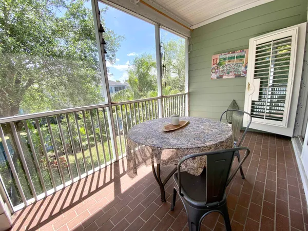 a view of a balcony with table and chairs