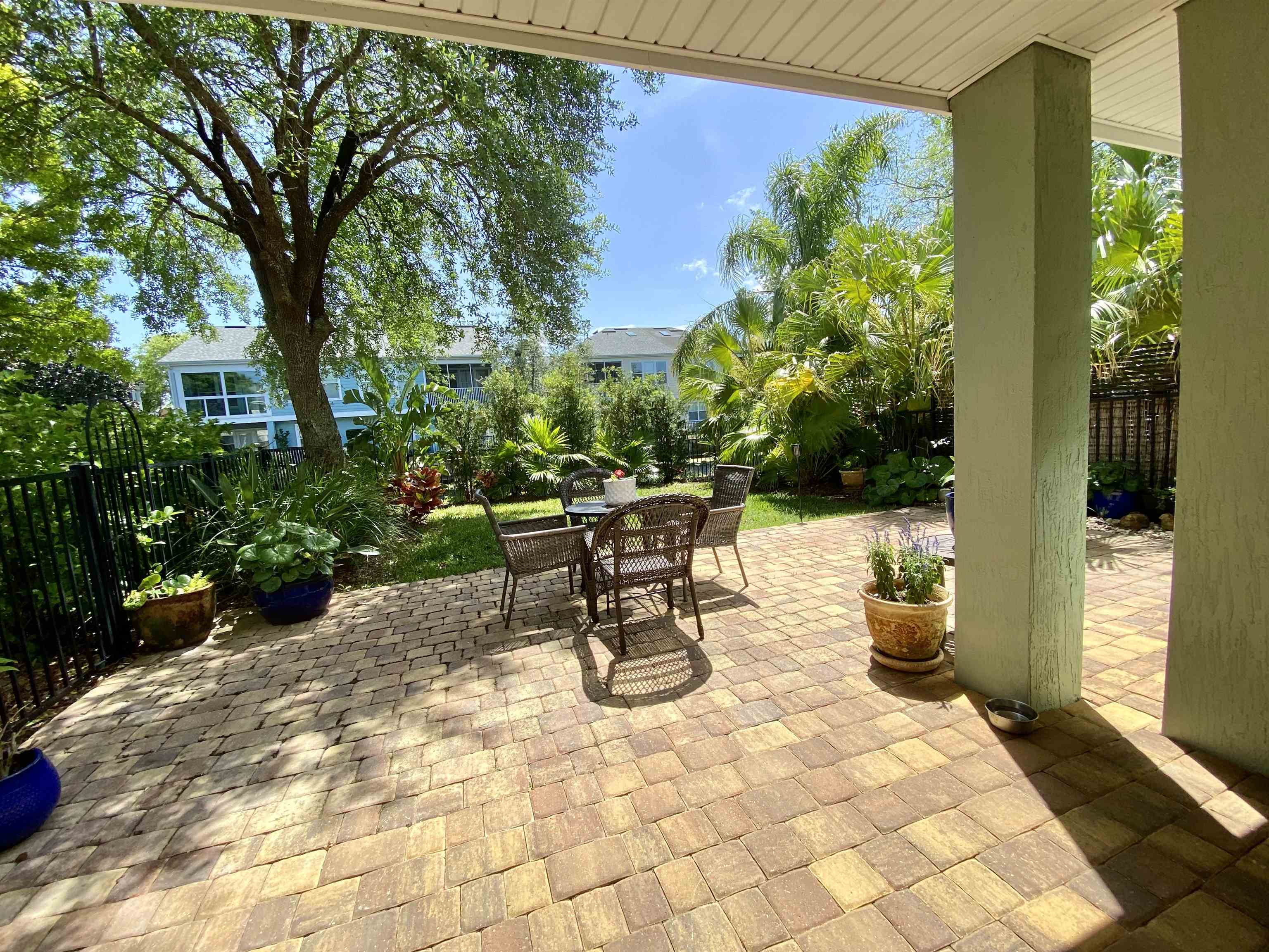 176 Sunset Circle North St. Augustine, FL 32080 - Photo 31 of 44 a view of a patio with a table and chairs and potted plants