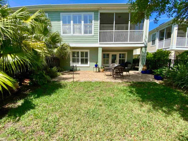 a table and chairs in front of a house