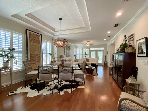 a living room with furniture large window and flat screen tv