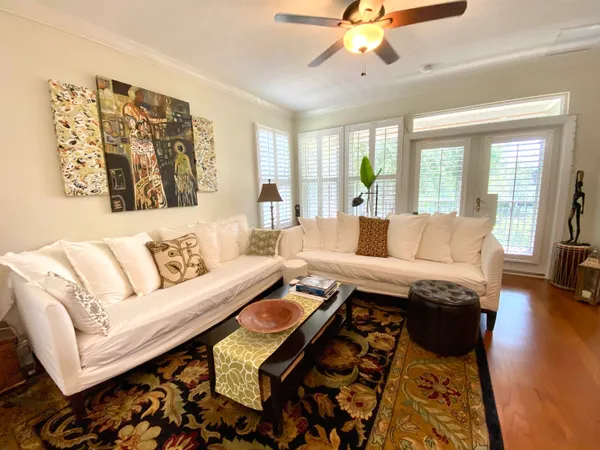 a living room with fireplace furniture and a large window