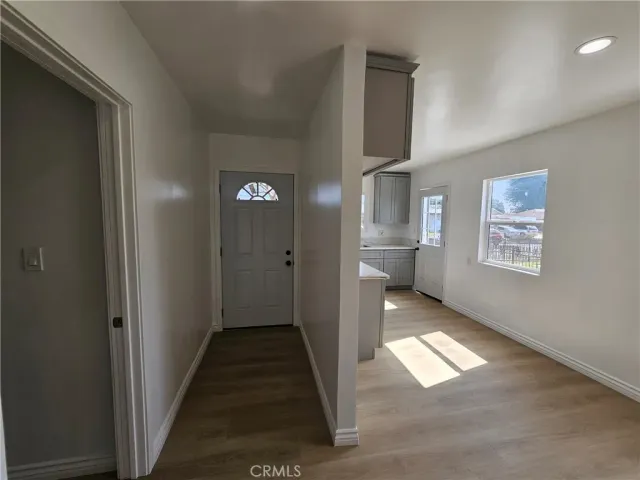 a view of hallway with wooden floor