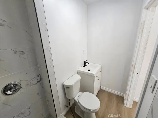 a white toilet sitting next to a small sink