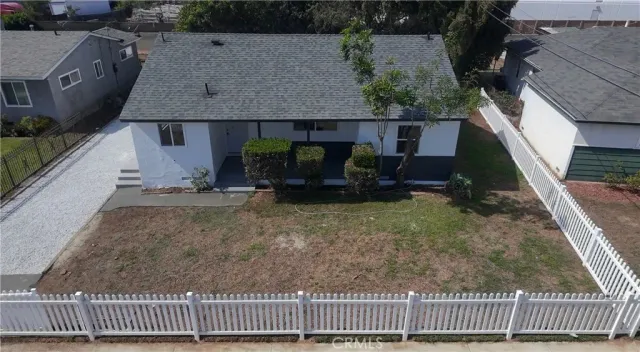 an aerial view of a house with a yard