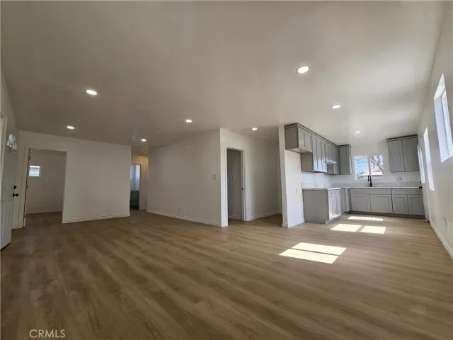 a view of kitchen with kitchen island granite countertop refrigerator and stove top oven