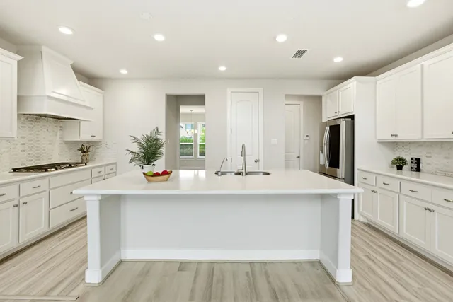 a view of kitchen with sink microwave and refrigerator