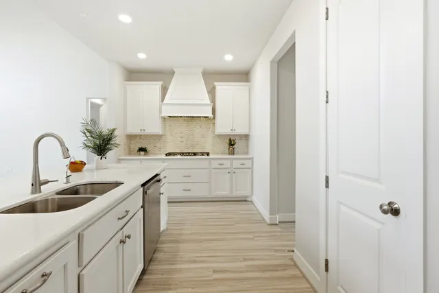 a bedroom with a large bed and a potted plant