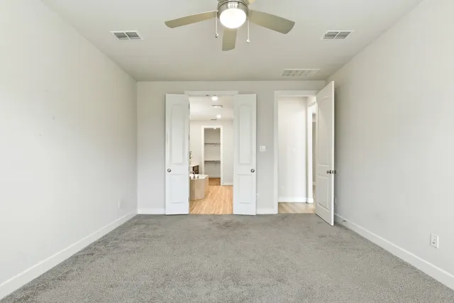 a spacious bathroom with a shower sink and a mirror