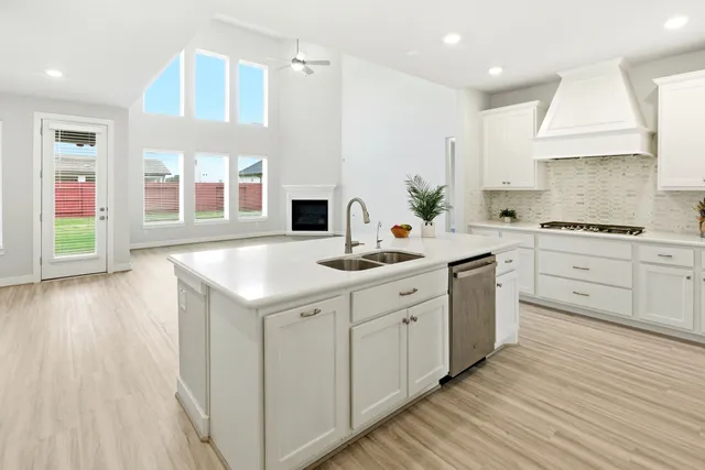 a kitchen with sink cabinets and wooden floor