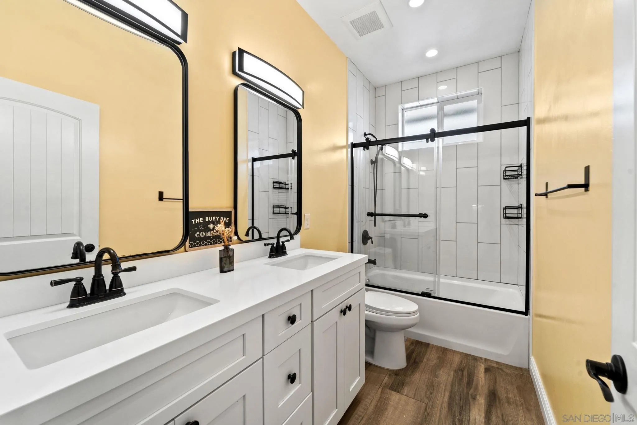 940 Passion Place Ramona, CA 92065 - Photo 17 of 25 a bathroom with a double vanity sink toilet mirror and shower