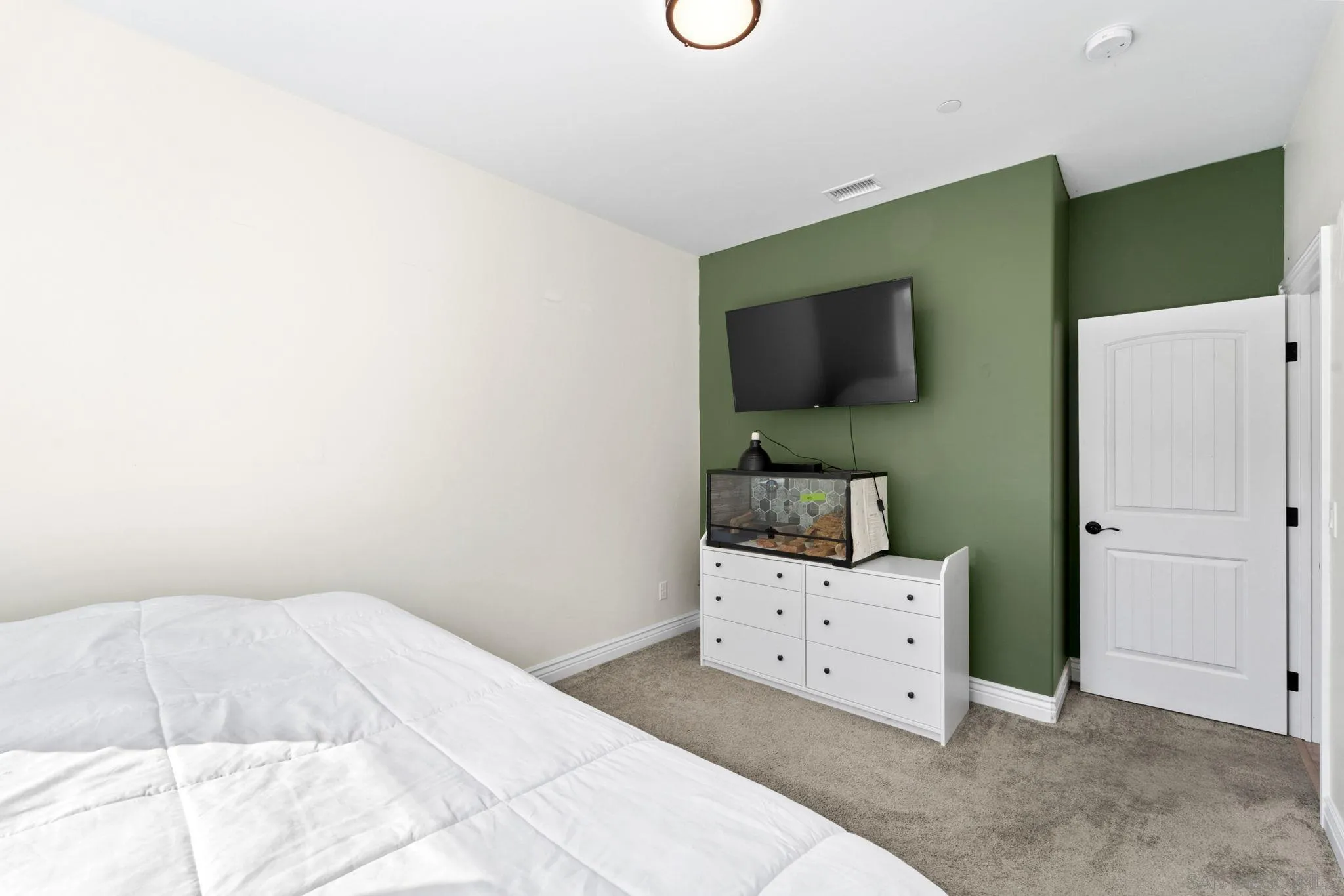 940 Passion Place Ramona, CA 92065 - Photo 21 of 25 a bedroom with a bed and a flat screen tv