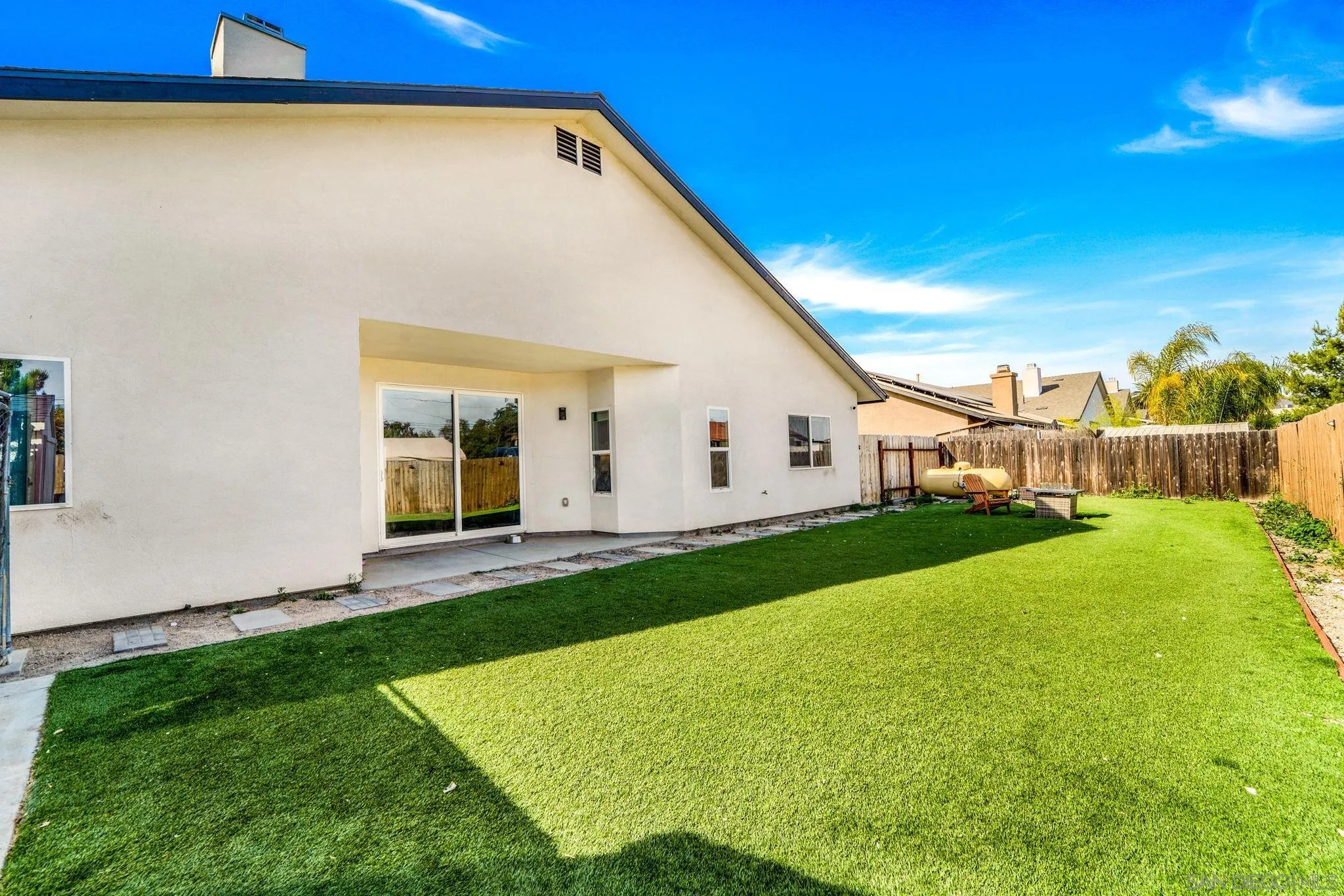 940 Passion Place Ramona, CA 92065 - Photo 23 of 25 a view of a white house with a big yard and large trees